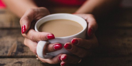 Hands holding a cup of coffee
